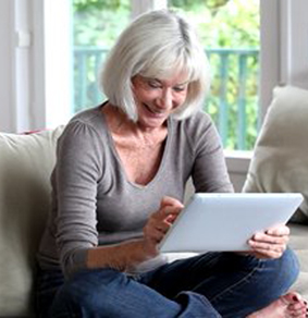 Senior Playing Game with Touch Screen Tablet PC
